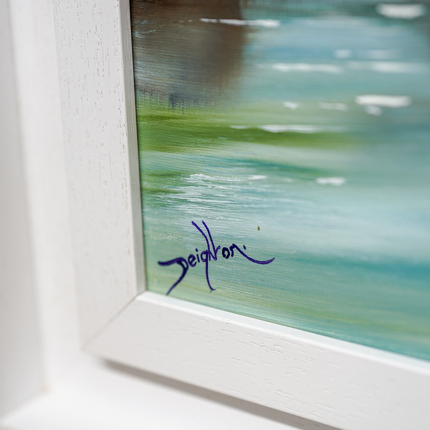 Close-up of a signature on a piece of art with a blurred background