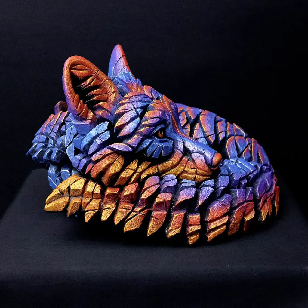 Colorful wolf head sculpture on a black background