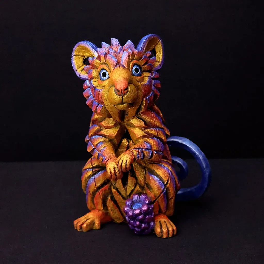 Colorful figurine of a stylized field mouse on a black background
