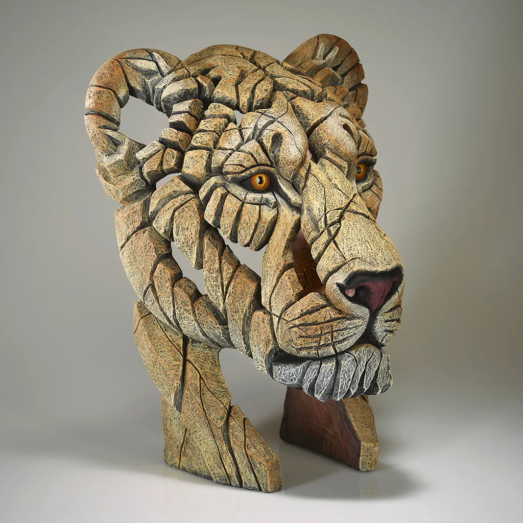 Sculpture of a Lions Head on a grey background