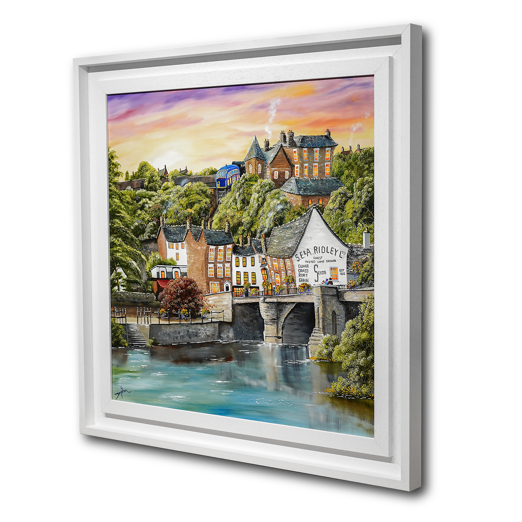 Framed artwork of a scenic town with a river and buildings.