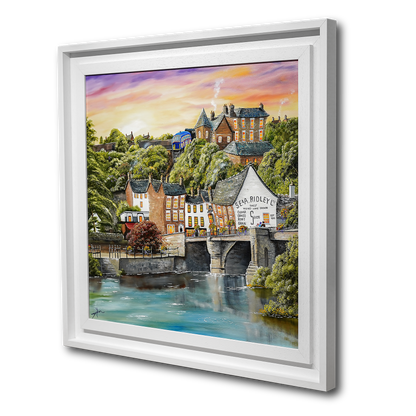 Framed artwork of a scenic town with a river and buildings.