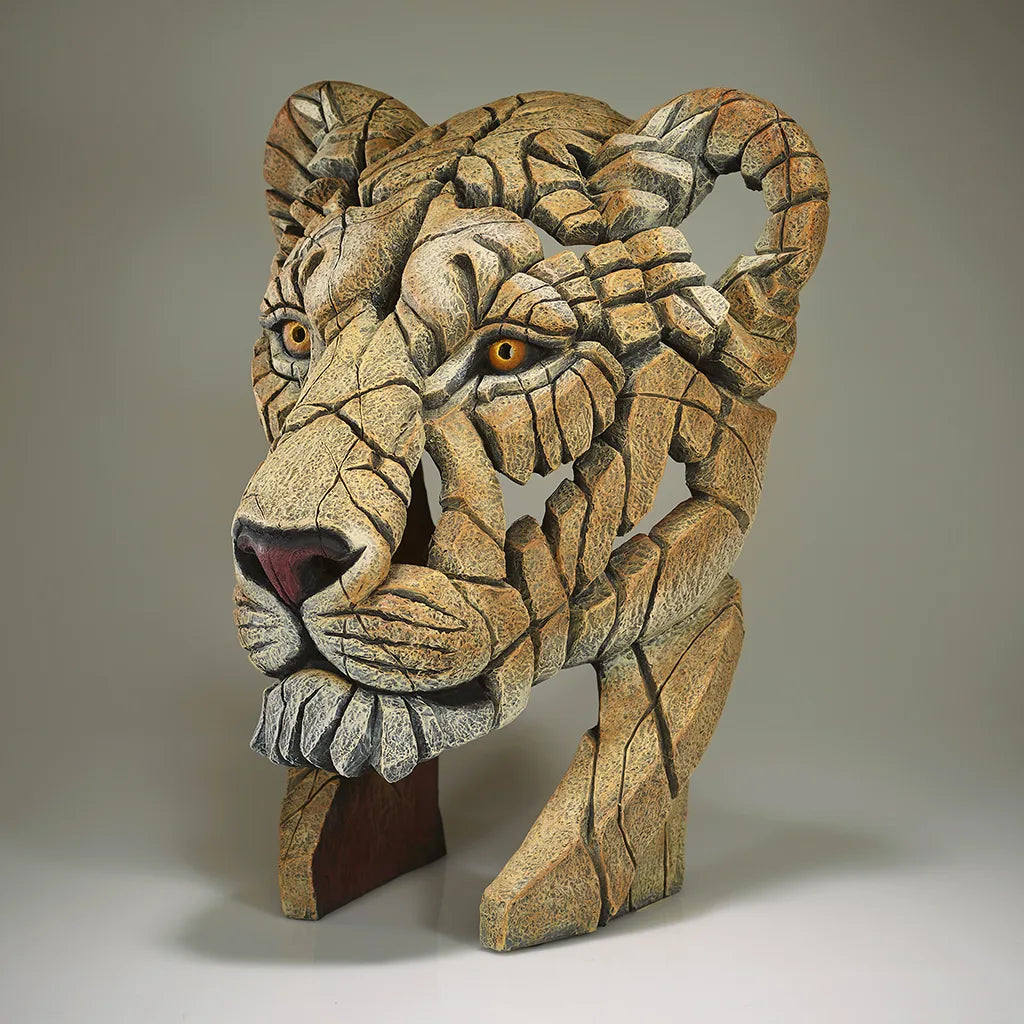 Sculpture of a Lions Head on a grey background