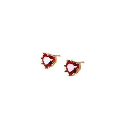 Heart-shaped red gemstone earrings with gold accents on a white background