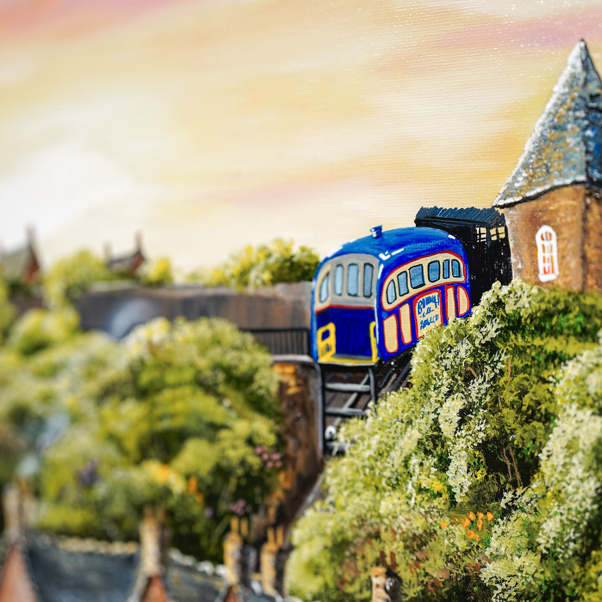 Painting of a blue and red train passing through a town with houses and trees.