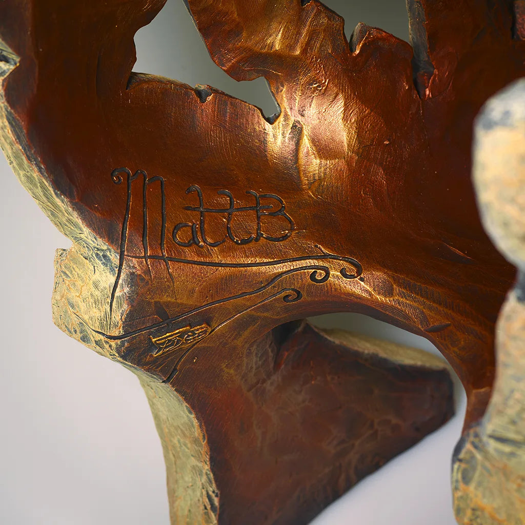 Close-up of a sculpture with 'MattB' branding on a white background