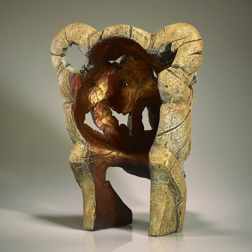 Back of a sculpture of a Lions Head on a grey background