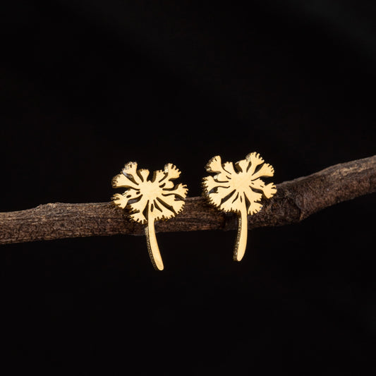 Gold floral dandelion earrings on a dark background