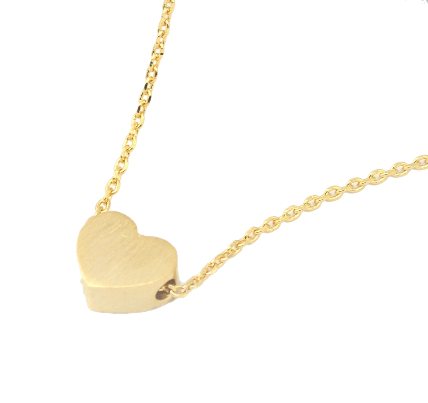 Gold heart-shaped pendant necklace on a white background