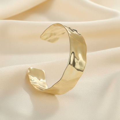 Gold bangle on a white background