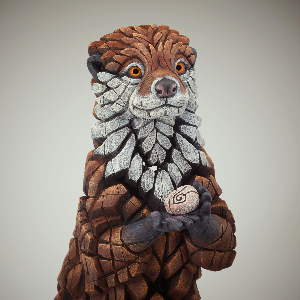Otter Sculpture from Edge Sculpture by Matt Buckley holding pebble.