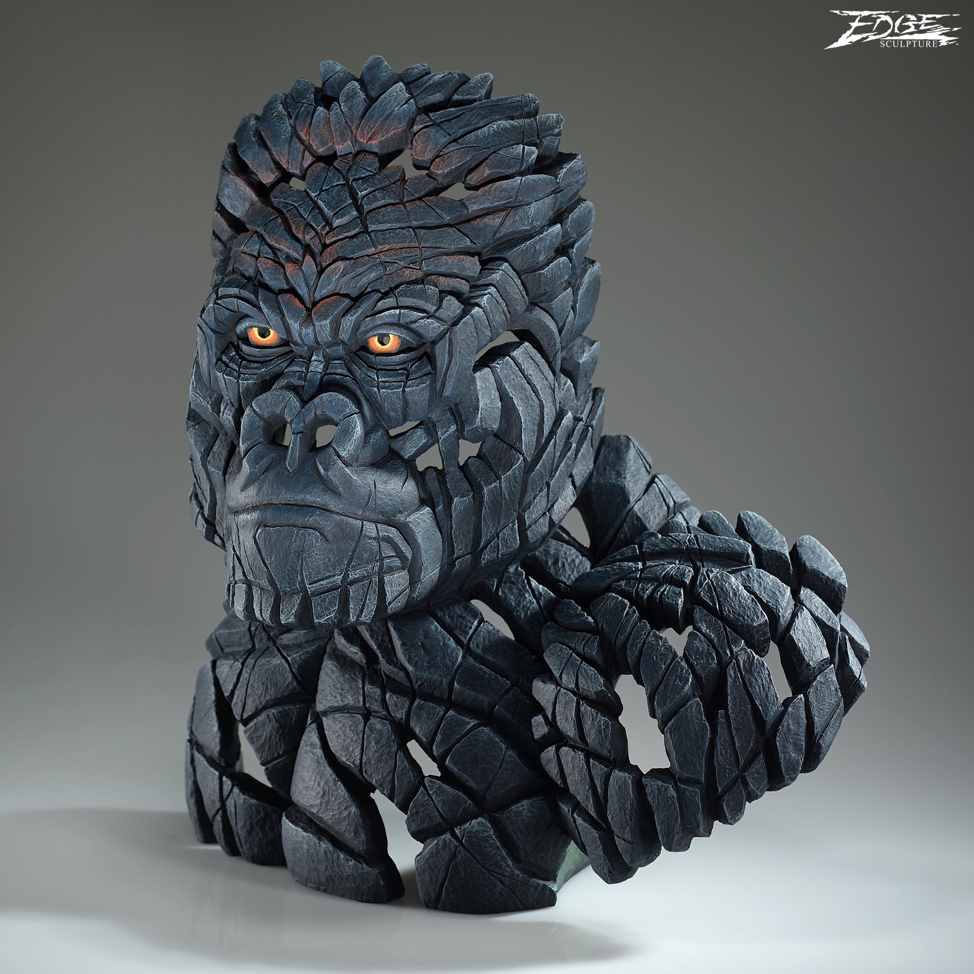 Statue of a gorilla with detailed texture on a gray background