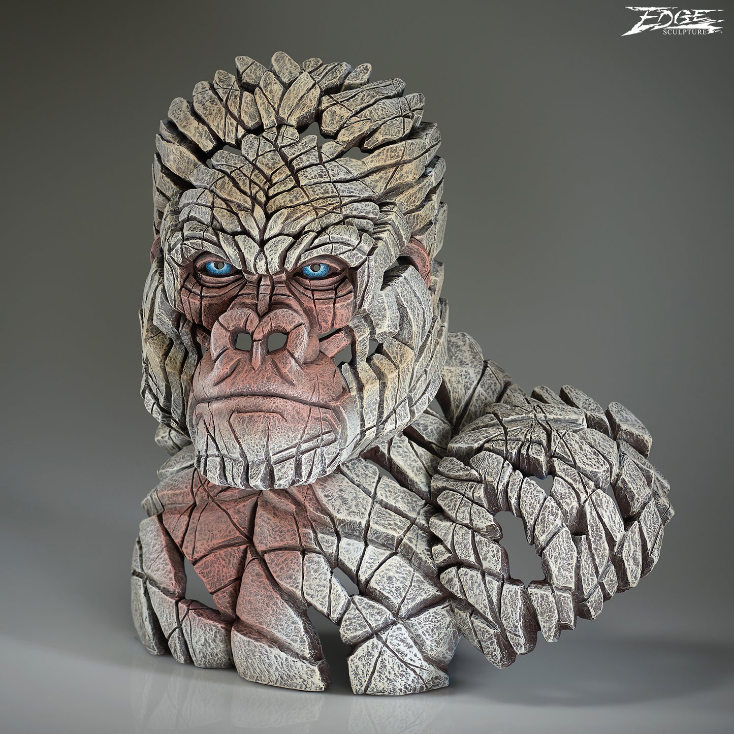 Stone-like creature with blue eyes on a gray background