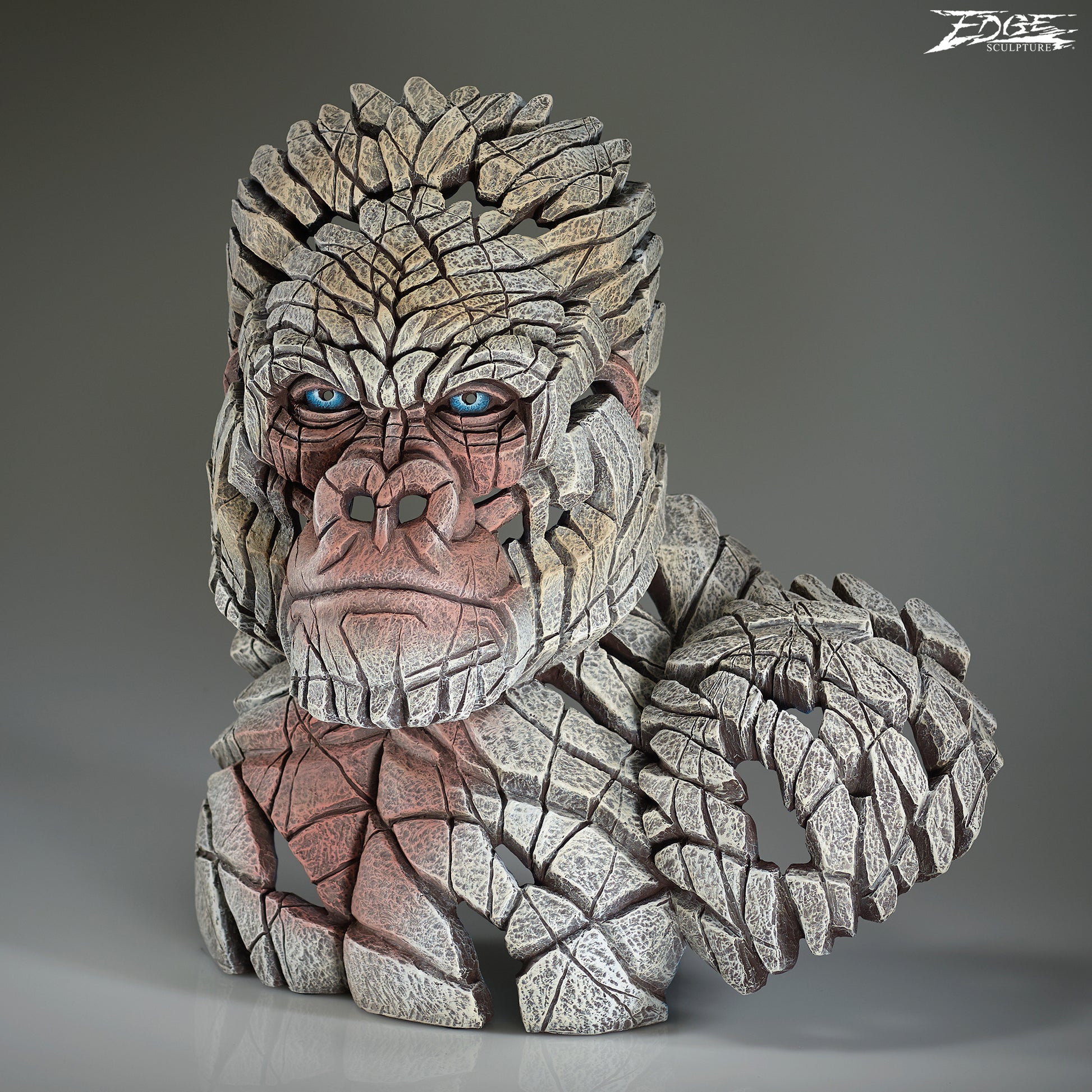Stone-like creature with blue eyes on a gray background