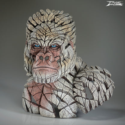 Stone-like creature with blue eyes on a gray background