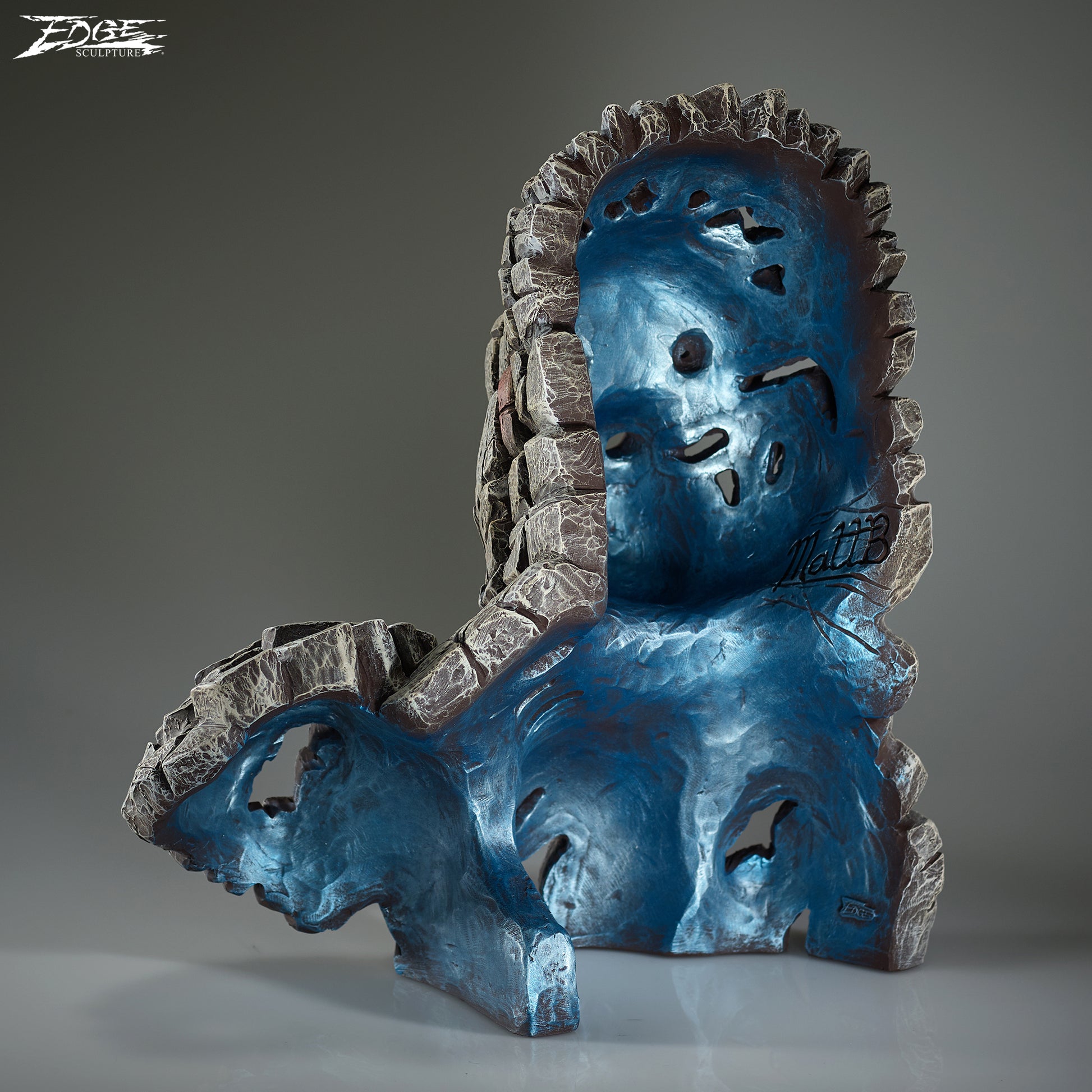 Blue and gray sculpture with abstract design on a gray background