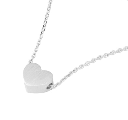Silver heart-shaped pendant on a chain against a white background