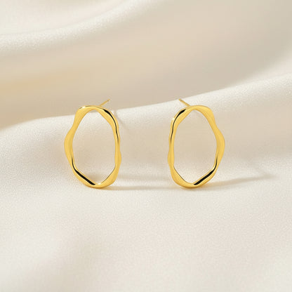 Gold hoop earrings on a white background