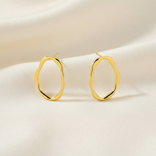 Gold hoop earrings on a white background