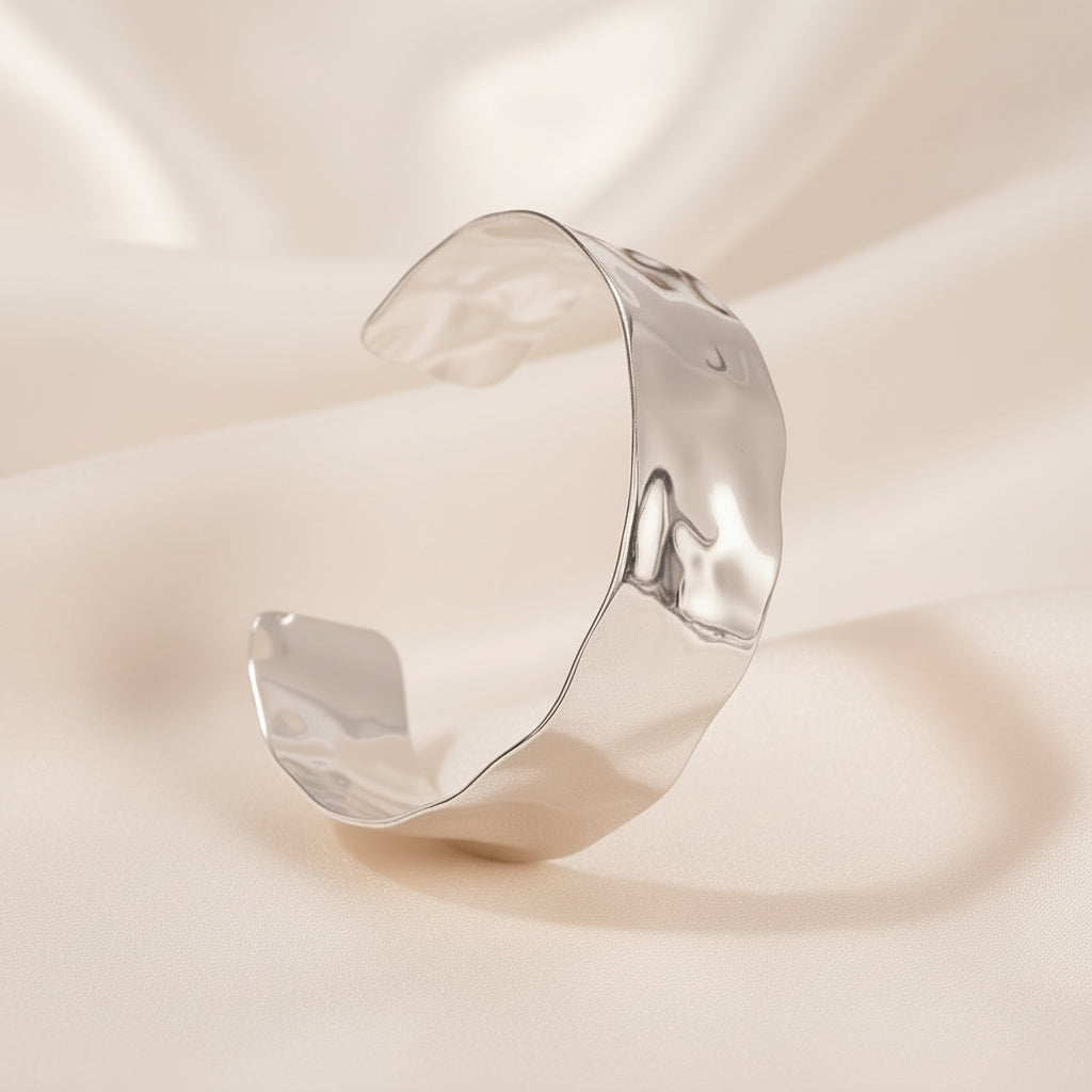 Silver cuff bracelet on a white background