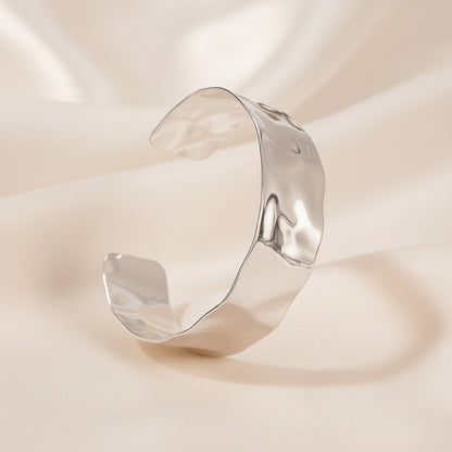 Silver cuff bracelet on a white background