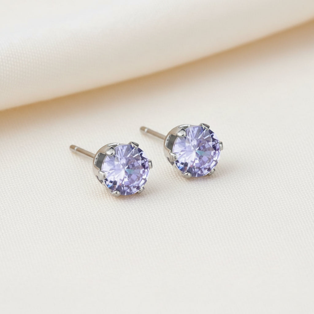 Pair of stud earrings with purple gemstones on a white background