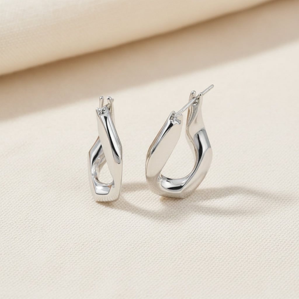 Pair of silver hoop earrings on a white background