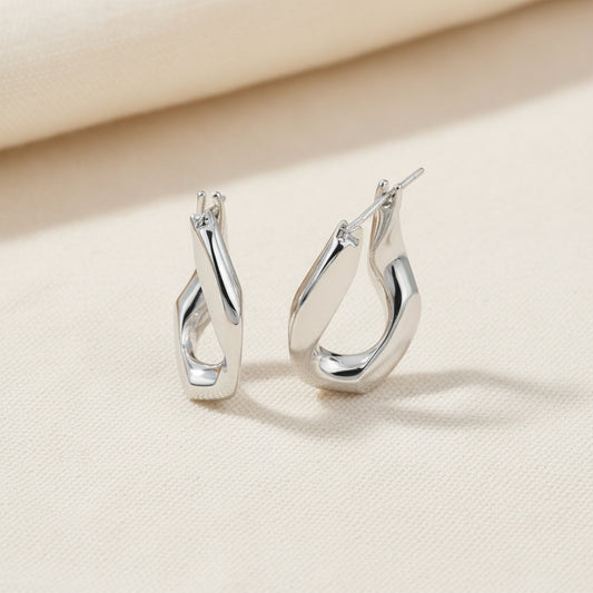 Pair of silver hoop earrings on a white background
