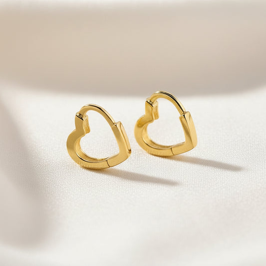 Gold heart-shaped hoop earrings on a white background